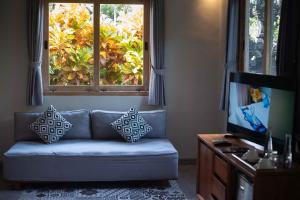 a living room with a couch and a window at Natya Hotel Tanah Lot in Tanah Lot