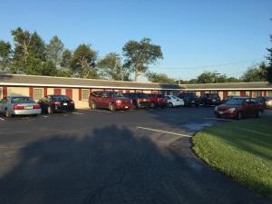 a parking lot with cars parked in front of a building at Boulevard Motel in Marmora