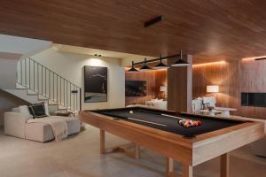 a living room with a pool table and a staircase at Villa Mangoni - Brand New Luxury Villa in Funchal