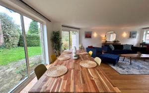 una gran mesa de madera en una sala de estar con sofá en Weybridge Stunning Five Bedroom House With Garden, en Oatlands Park