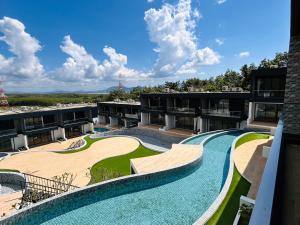 an apartment building with a large swimming pool at Tierra Utopia 