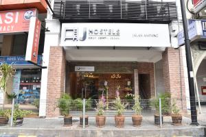 a building with potted plants in front of a store at J Hotel Masjid India KL in Kuala Lumpur