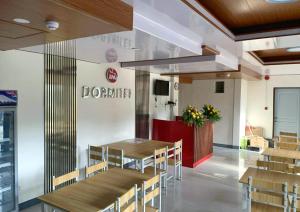 a dining room with tables and chairs in a restaurant at RM Dormitel by RedDoorz in Butuan