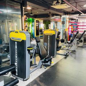 a gym with a row of treadmills and machines at Tân Bình Hotel in Ho Chi Minh City