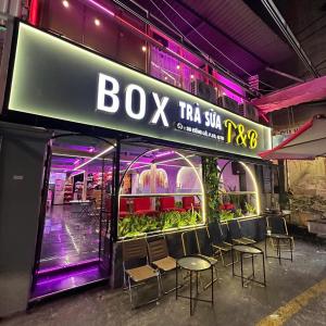 a building with chairs and a sign for a box tea shop at Tân Bình Hotel in Ho Chi Minh City +54 photos