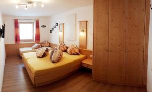 a bedroom with two beds with pillows on them at Riedlhof - Leogang in Leogang