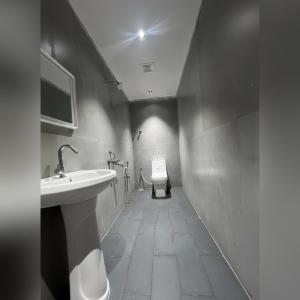 a bathroom with a sink and a toilet at Silk White in Hyderabad