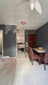 a dining room with a table and purple chairs at Apartamento da Letícia in Camaçari