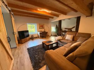 a living room with a couch and a tv at Urlaub in der Natur in Lüdenscheid +35 photos
