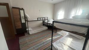 a small room with two bunk beds and a mirror at Mareda house in Midyat