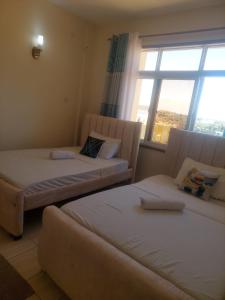 Ένα ή περισσότερα κρεβάτια σε δωμάτιο στο Millville Apartments Shanzu +19 φωτογραφίες