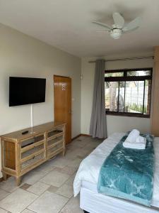 a bedroom with a bed and a flat screen tv at Daisy Accommodation & Spa in Cape Town +21 photos