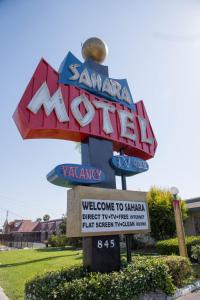 a large sign for aasymitemite sign at Sahara Motel in Anaheim