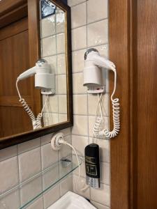 a bathroom with two blow dryers and a mirror at Pensjonat Alpejski Dwór in Miedzygorze +177 photos