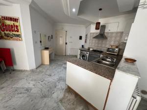 a kitchen with a sink and a counter top at chott meriem cozy apartment in Akouda +4 photos