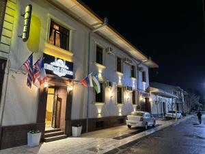 a building with flags on the side of a street at Hotel Butique Biluri S in Samarkand +31 photos