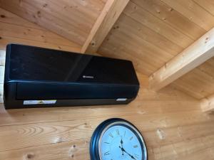 a clock next to a box and a clock on a wall at Wellness Ferienwohnung mit Sauna, Massagen, Spa, beheizbarem Whirlpool bei Leipzig in Pomssen