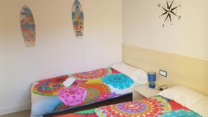a bedroom with two beds and a surfboard on the wall at Casa Palmeres in Torroella de Montgrí
