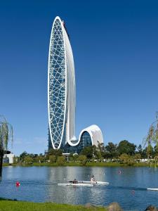 a building on a lake with people in a boat at Apartment with sea View in Batumi