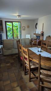 a dining room and living room with a table and chairs at Villa Pierrette - Quiet house with garden in Saint-Jorioz +8 photos