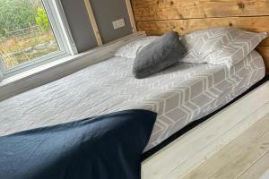 a bed in a room with a window at Glamping Hut - Sleeps up to 4 Hot Tub & Parking in Welshpool