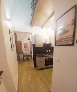 a room with a kitchen with a stove top oven at ACQUARIO 11 in Genova