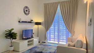 a living room with a large window with a television at Eira Homestay Lost World Of Tambun M uslim only in Ipoh
