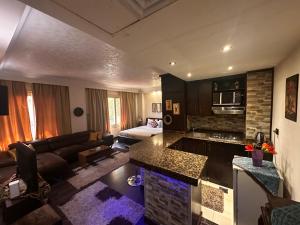 a kitchen and living room with a couch and a table at Hotel apartment in Monte Cairo Mokattam d202a in Cairo