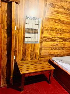 a wooden bench in a room with a window at Kithaya Ella in Ella +135 photos
