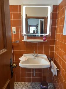 a bathroom with a sink and a mirror at Landhaus Christina Alpbach in Alpbach