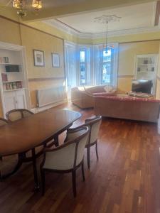 a living room with a table and chairs and a couch at Crawford House in Largs