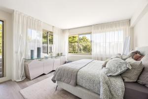 a bedroom with a bed and a large window at Riviera luxury estates in Antibes
