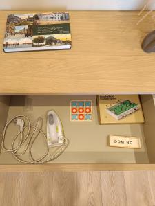 a wooden drawer with a mouse and other items in it at Windy City apartments in Liepāja