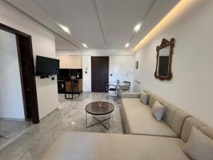 a living room with a couch and a table at la soukra cozy apartment in La Soukra