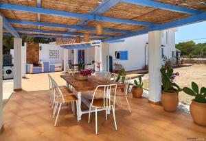 a patio with a wooden table and chairs at Casa Codol in Illes Balears