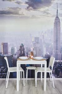 a white dining room with a view of the city at Simple and Modern, apartament with rating 10 out of 10, WiFi, parking, air conditioning, free cancelation in Timişoara