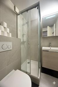 a bathroom with a shower and a toilet and a sink at CHL Stay apartment One-Bedroom Apartment Steps from Luxembourg Hospital-Private Garden Included in Luxembourg
