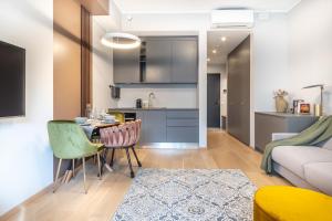 a kitchen and a living room with a table and chairs at City center!AC,free parking,terasse in Pärnu