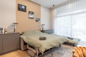 a bedroom with a bed with two towels on it at City center!AC,free parking,terasse in Pärnu