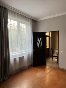 a room with a door with a logo on it at Gyumri Home in Gyumri