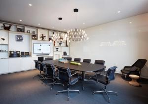 a conference room with a large table and chairs at citizenM Copenhagen Radhuspladsen in Copenhagen