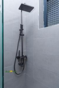 a shower in a bathroom with a shower head at Ikamba-Lakeview Apartment in Kampala +7 photos
