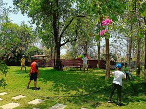 a group of people playing in a park at MARS Nature Resort in Shāhāpur