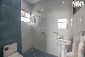 a bathroom with a sink and a toilet and a sink at StayVista at Echoes by the Aravalli with Bonfire, Lawn in Jaipur +21 photos