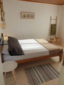 a bed in a room with a wooden frame at Quinta de Natureza in Nabais