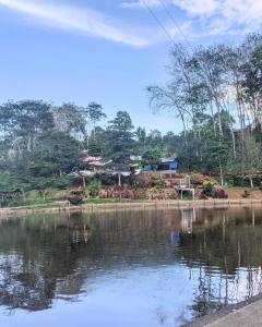 a body of water with a village in the background at KA Tent 