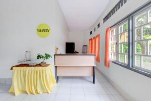 a room with a table with a yellow table skirt at Dancenter Stipram Kaliurang in Kaliurang