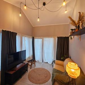 a living room with a couch and a flat screen tv at ZIG ZAG Apartment 8- Old Town in Constanţa