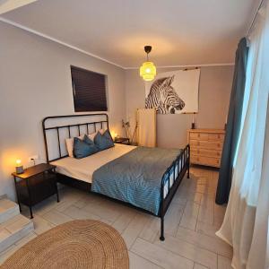 a bedroom with a bed with a zebra picture on the wall at ZIG ZAG Apartment 8- Old Town in Constanţa +27 photos
