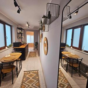 a room with two tables and chairs and a kitchen at ZIG ZAG Apartment 8- Old Town in Constanţa